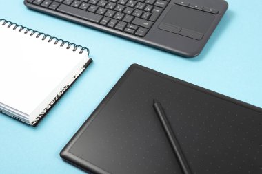 grafik tablet ve klavye mavi bir arka plan üzerinde. Metin, alan defter.
