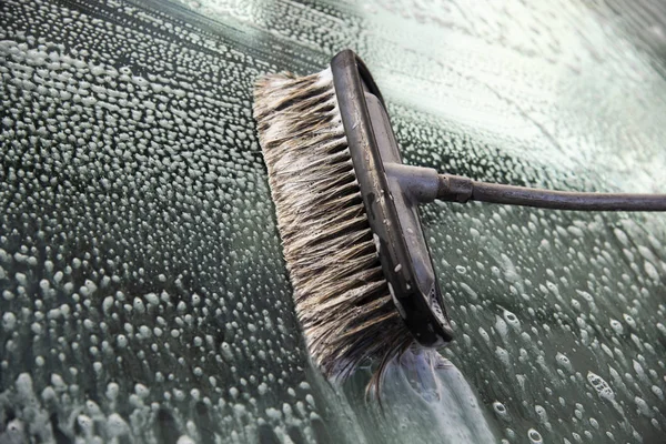Brush for cleaning glass. Car wash with a brush, hand wash