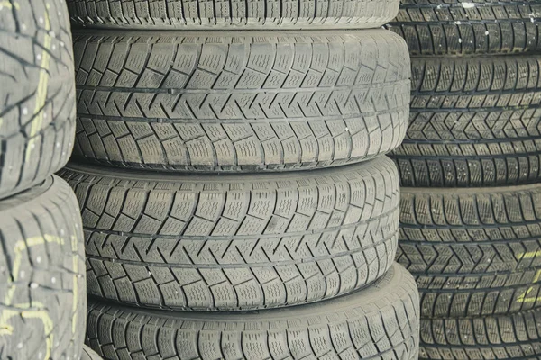 Old and used car tires. Background. Car tires in storage. Car tire recycling