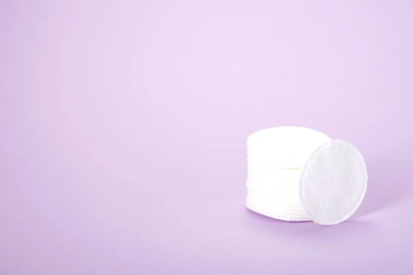 Cosmetic cotton pads. A stack of cotton pads on a delicate pink background. spa. close-up