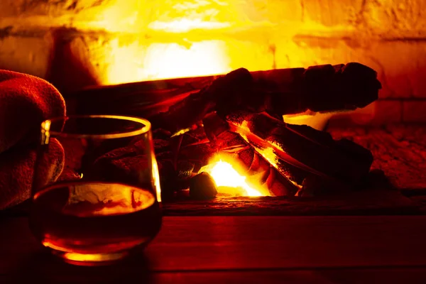 Glass of alcoholic drink wine in front of warm fireplace. Magical relaxed cozy atmosphere near fire — Stock Photo, Image