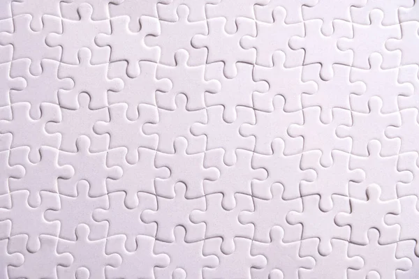 Puzzle background, white puzzle consists of many pieces — Stock Photo, Image