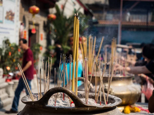 Incense sticks on joss stick pot burning and smoke used to pay r