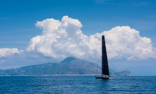 Sailing. Ship yachts with black sails in the sea