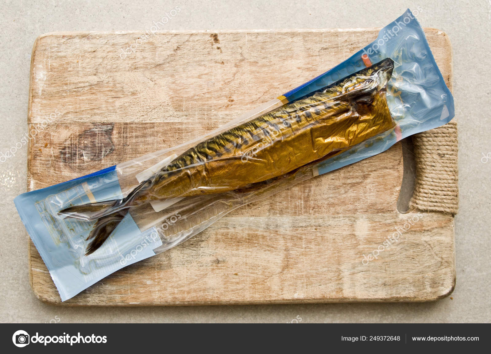 Vacuum packed mackerel fish on cutting board Stock Photo by ©AHatmaker