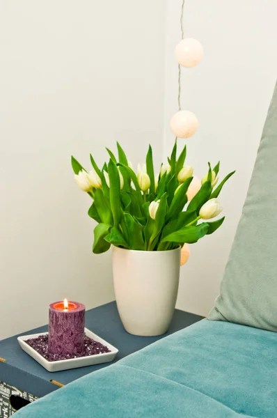 Bedroom decoration, corner with tulips and candle