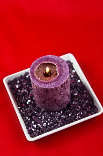Violet candle composition on red background — Stock Photo, Image