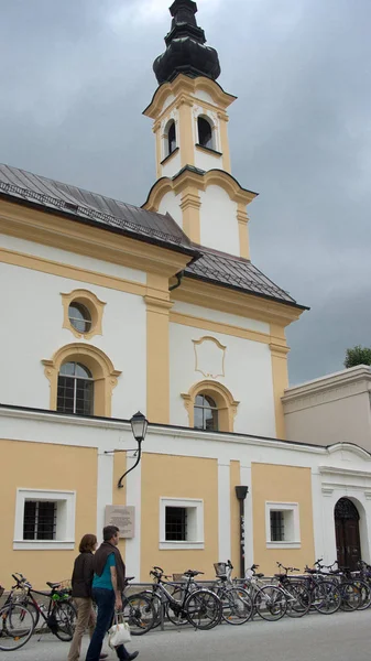 Catholic yellow white church in salzburg — Stock Photo, Image