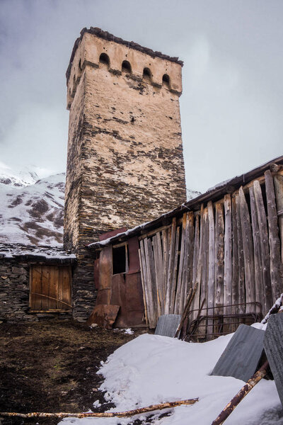 old wooden cabin in front of defence tower