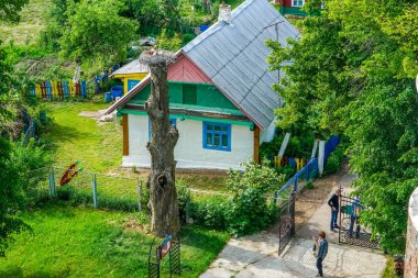 Kutup, leylek yuvası nerede küçük çocukların leylek beslenir. Yakın, çitin arkasında renkli eski ahşap evi değil. Havadan görünümü