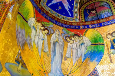 ZHOVKVA, UKRAINE - JANUAR 01, 2019: Wall Painting with Angels and the Holy Mary by artist J. Bucmaniuk on the ceiling of a chapel in the Ukrainian Greek Catholic Church of the Sacred Heart clipart