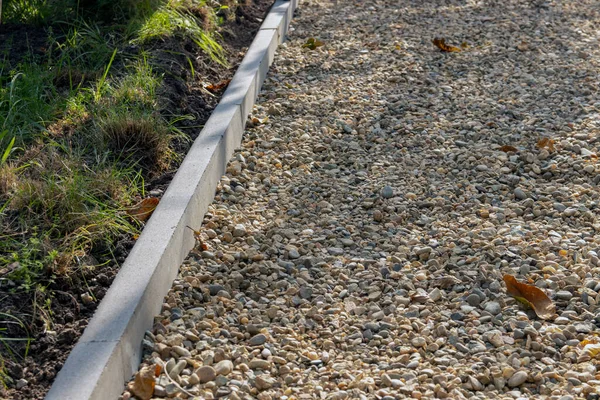 Prepared base for tiling. Stacked and tamped rubble at the base. Selective focus.