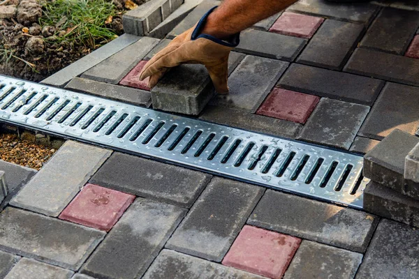 Gutter, gutter, drain for water after rain on the sidewalk. Installation of paving slabs and drainage systems. Sidewalk construct Selective focus