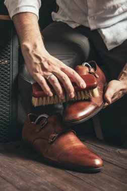 Bootblack bir fırça ve Ayakkabı Lehçe ile kahverengi keşiş Ayakkabı temizler