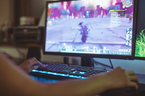 WROCLAW, POLAND -  SEPTEMBER 04th, 2018: Woman playing World of Warcraft: Battle of Azeroth game. WoW is a massively multiplayer online role-playing game (MMORPG) released in 2004 by Blizzard Entertainment.