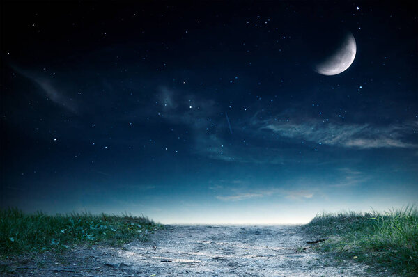Magic landscape with road and grass over night sky. Moon on this image furnished by NASA