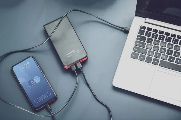 Powerfull power bank charges two devices at one time via USB-C connection — Stock Photo, Image