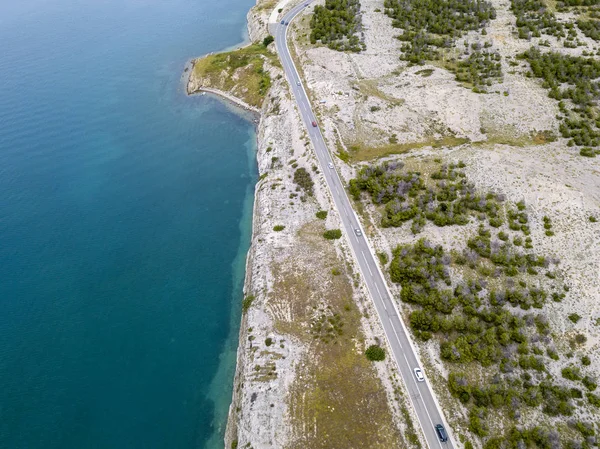 Aerial view of the coast of Croatia, winding roads and coves with crystal clear sea. Coast of the island of Pag