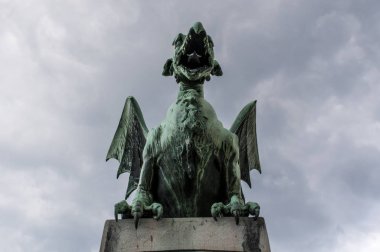 Slovenia, 24/06/2018: the Dragon statue by Jurij Zaninovi on the Dragon Bridge (Zmajski most), the most famous road bridge of Ljubljana built in the early 20th century under the Austro-Hungarian Monarchy  clipart