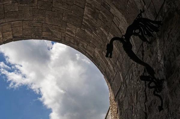 Slovenia, 24/06/2018: iron dragon hanging on a wall of the Ljubljana Castle (Ljubljanski grad), former medieval fortress of the 11th century standing on Castle Hill above downtown of the capital city