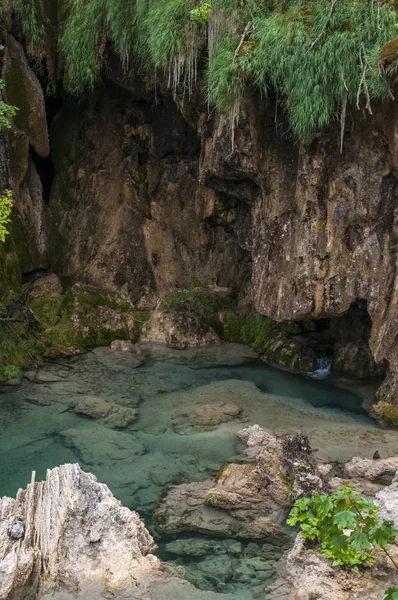 Croatia, 28/06/2018: rocks, cave and lake at Plitvice Lakes National Park, one of the oldest parks in the State, in the mountainous karst area of central Croatia at the border to Bosnia Herzegovina