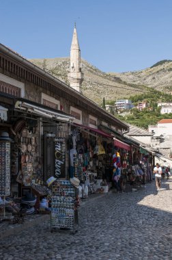 Bosna, 5/07/2018: Mostar eski kasaba mağazaların Hadzi-Kurt Camii veya Tabacica camii minaresi manzarasına sahip 16 ve 17 yüzyıllar Neretva Nehri arasında sağ yakasında inşa