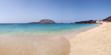 Canary Islands, Spain, 12/09/2018: panoramic view of the paradise beach Playa de Las Conchas in the north of La Graciosa, the main archipelago island Chinijo, a mile northwest of Lanzarote  clipart