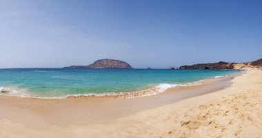 Canary Islands, Spain, 12/09/2018: panoramic view of the paradise beach Playa de Las Conchas in the north of La Graciosa, the main archipelago island Chinijo, a mile northwest of Lanzarote  clipart