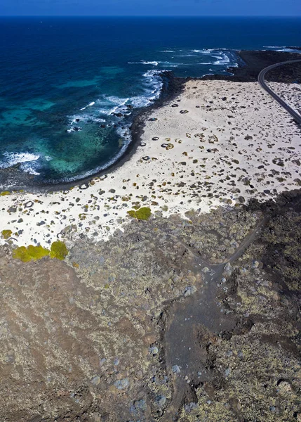 Aerial view of the Spiral Caleta, spiral beach, pebbles on the ground forming a spiral. Orzola, Lanzarote, Canary Islands, Spain. Africa. Beach and rugged coastline of volcanic origin and crystal clear sea