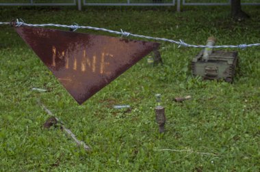 Sarajevo, 08/07/2018: barbed wire and warning sign for landmines in the reproduction of a minefield at the Sarajevo Tunnel Museum which housing the underground tunnel built in 1993 during the Siege of Sarajevo clipart