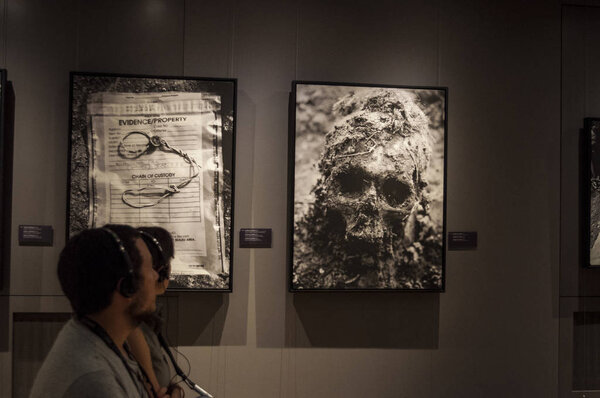 Galerija museum, Sarajevo, 08/07/2018: people watching pictures from mass graves and cemetery of the victims of Srebrenica massacre, the July 1995 Bosniaks genocide perpetrated by Bosnian Serb Army