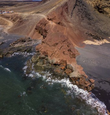 Bir kaya oluşumu üzerinde çökmesini dalgalar hava görünümünü. Playa El Golfo. Siyah beach Charco de Los Clicos. Lanzarote, Kanarya Adaları, İspanya