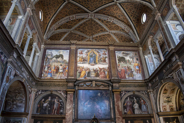 Milan, Italy, Europe, 03 / 28 / 2019: San Maurizio al Monastero Maggiore, a 1518 church known as the Sistine Chapel of Milan, details of altarpiece and the partition wall in the faithful 's area with the frescoes by Aurelio Luini
