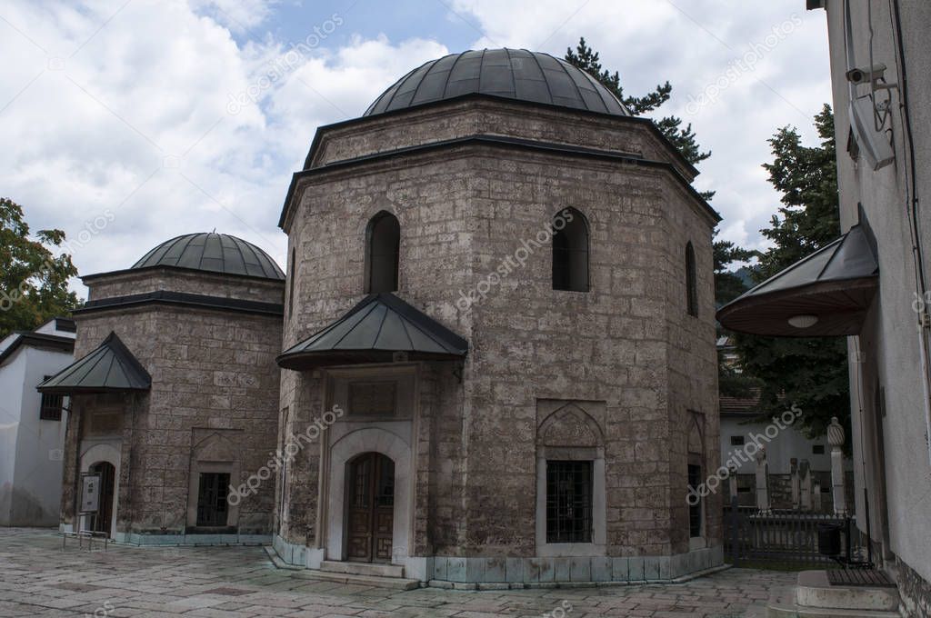 Sarajevo, Bosnia and Herzegovina, 07/08/2018: the two Mausoleums on the eastern side of the Gazi Husrev-beg Mosque (1532), the largest historical mosque in Bosnia, housing the grave of Gazi Husrev Beg and Murat Beg Tardic