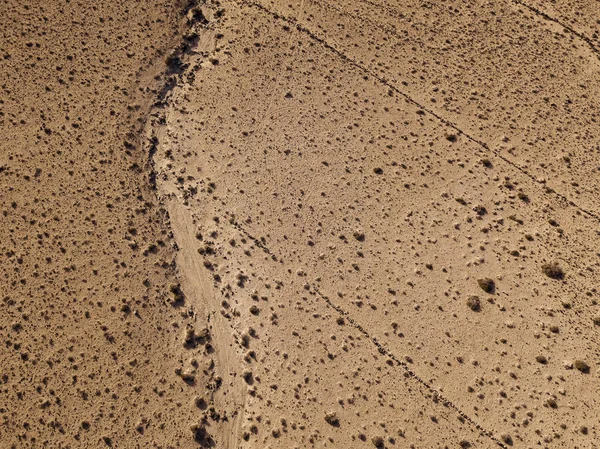 Aerial view of a desert landscape on the island of Lanzarote, Canary Islands, Spain. Desert background, texture. Sand and desolate land