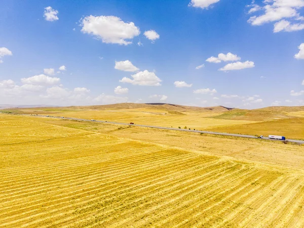 Aerial view of the road and fields near the Lake Tuz, Tuz Golu. Salt Lake. it is located in the Central Anatolia Region, Ankara, Aksaray, Konya. Highway and trucks on the street