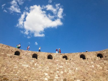 Ankara Kalesi'nin (Kale) duvarlarının panoramik manzarası, duvarlarda yürüyen insanlar. Bulutlarla güneşli bir gün. 06/27/2019. Türkiye'nin başkenti. Tarihi eser