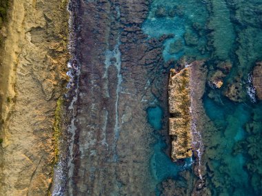 Aerial view of rocks in the sea. Overview of the seabed seen from above, transparent water. Seabed. Pizzo Calabro, Calabria, Italy clipart