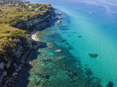 Calabrian sahilinin hava manzarası, kristal berrak deniz ve lüks villalara bakan kayalıklar. Tropea 'nın güneyindeki Riaci bölgesi. Calabria. İtalya