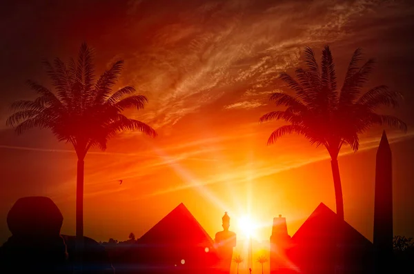 Travel and exploration, adventure. Holidays in Egypt. Archeology and history of the pharaohs, pyramids, obelisks, sphinxes and palm trees at sunset. Photograph the monuments. Sunset silhouette. 3d render
