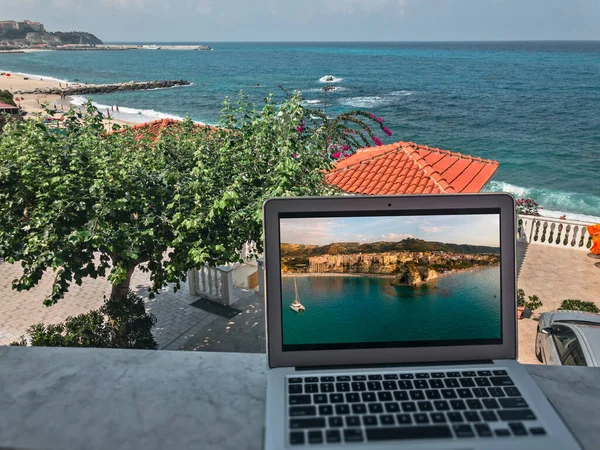 Smart working, work station. Working while on vacation. Choosing the right place to work from home. Covid-19 changes in the world of work. Computer, internet connection. Tropea. Italy