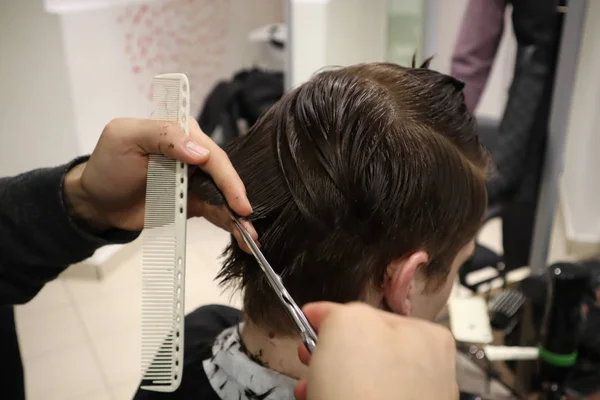 主美发师做发型和风格与剪刀和梳子 主人在理发店里堆叠男人的头发 理发师为年轻人做发型 理发店 — 图库照片