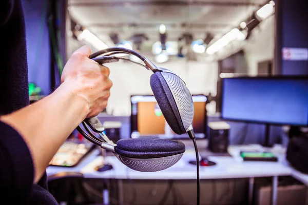 Young Man Holds Headphones Recording Studio Buttons Studio Screens Equipment — Stock Photo, Image
