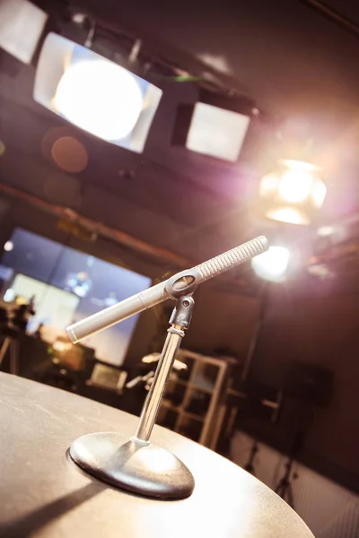 Metal microphone in the studio, studio lights in the blurry background