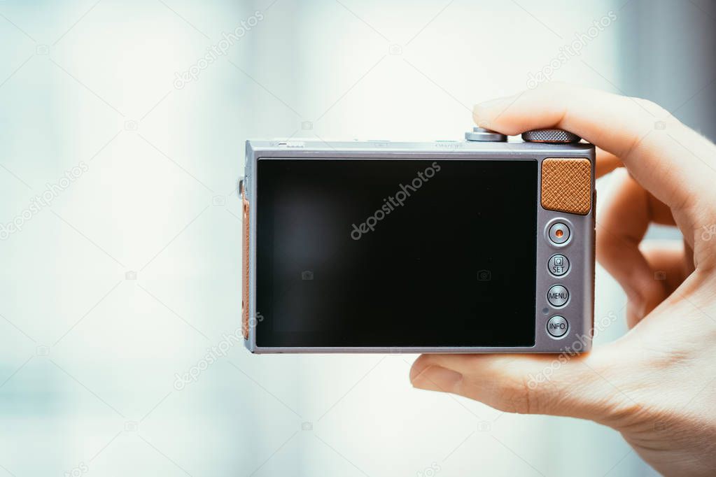 Reverse side of a digital camera, black lcd screen and some keys, business style