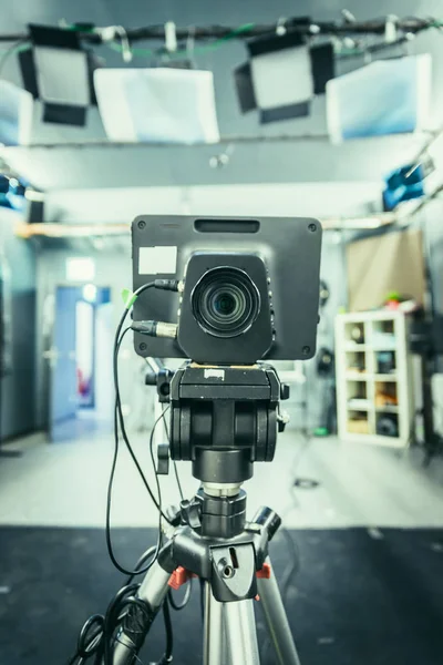 Lens of a film camera in an television broadcasting studio, spotlights and equipment