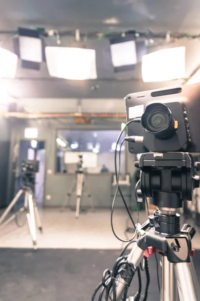 Film camera on a tripod in a television broadcasting studio