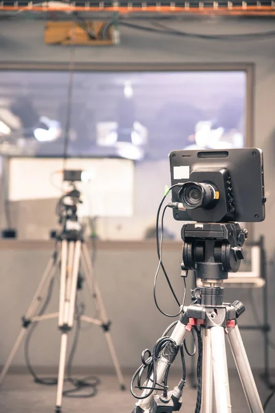 Film camera on a tripod in a television broadcasting studio