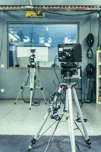 Film camera on a tripod in a television broadcasting studio