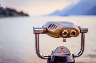 Turist dürbün göl kenarında Lago di Garda, akşam sahne su ve dağ